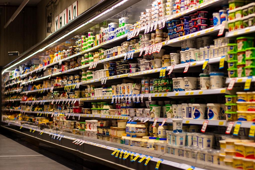 Shopping cart filled with groceries in a store aisle